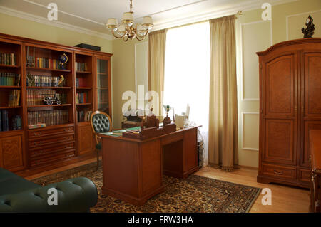 Bookcase, table and chair in a cabinet Stock Photo