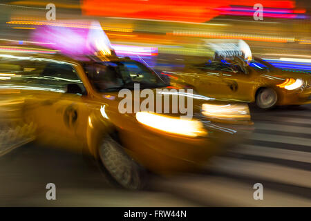 Blurry abstract photo of yellow taxi cabs in motion in Manhattan, New York City Stock Photo