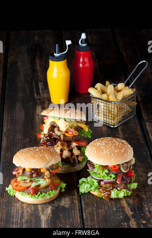 Large hamburger with fries and ketchup and mustard in bottles Stock Photo