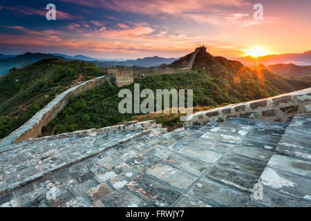 Sunset from atop the Jinshanling portion of the Great Wall of China. Situated 125 km northeast of Beijing. Stock Photo