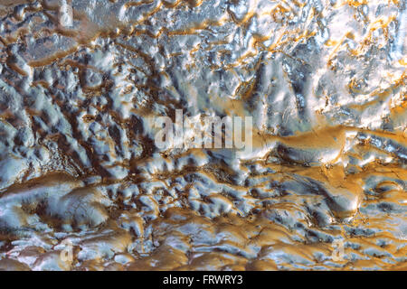 Abstract metallic pattern in bluish silver with ocher and brown in close-up Stock Photo