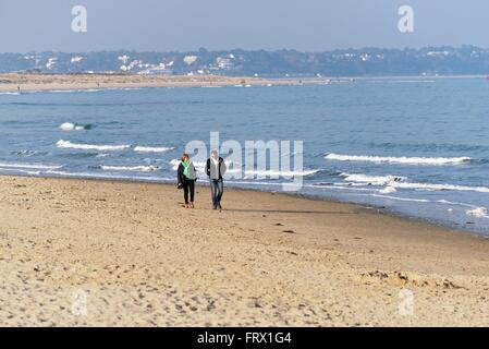 Middle aged couple walking on the beach at Studland Bay Dorset uk Stock Photo