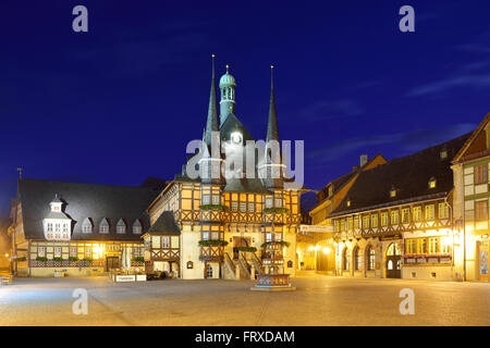 View over market square to illuminated town hall, Wernigerode, Saxony-Anhalt, Germany Stock Photo