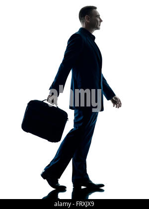 one caucasian business man walking side view silhouette isolated on white background Stock Photo