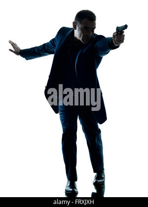 one caucasian man with a handgun silhouette isolated on white background Stock Photo