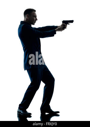 one caucasian man with a handgun silhouette isolated on white background Stock Photo