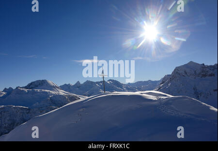Summit cross in the skiing area of Lech in Arlberg, Winter in Vorarlberg, Austria Stock Photo