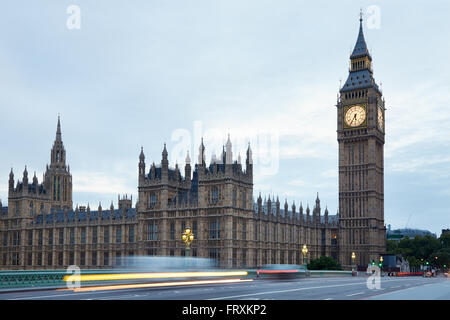 Big Ben and bridge in the early morning, car passing lights in London Stock Photo