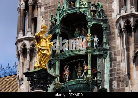 St. Mary's column, Mariensaeule on Marienplatz square with town hall chimes, Munich, Upper Bavaria, Bavaria, Germany Stock Photo