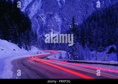 Streaking Car Tail Lights on a Road in Winter, Banff National Park, Alberta, Canada Stock Photo