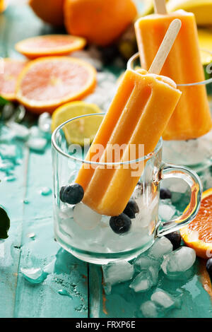 Mango banana popsicles on ice Stock Photo