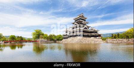 Matsumoto, Japan - May 13, 2012: Panoramic view of Matsumoto castle with it's black and white wooden keep and stone block walls Stock Photo
