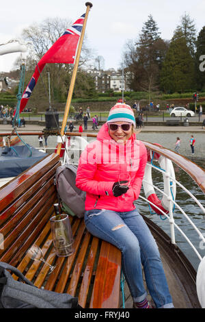 Lake Windermere Cumbria 25th March 2016 . UK Weather Sunny afternoon-the passenger steamer The Swan (built 1938) at Bowness Bay pier head at -Tourist enjoying trip dressed for the cold -plus wine in ice bucket & glasses Credit:  Gordon Shoosmith/Alamy Live News Stock Photo