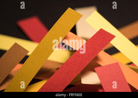 Colourful strips of cardboard as texture and background on black background Stock Photo