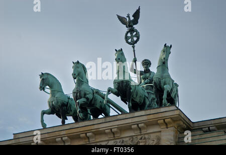 The quadriga located atop the Brandenburg Gate in Berlin, Germany,  was designed by Johann Gottfried Schadow in 1793 as the Quad Stock Photo
