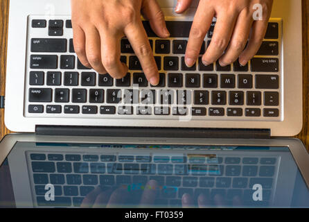hand typing on laptop Stock Photo