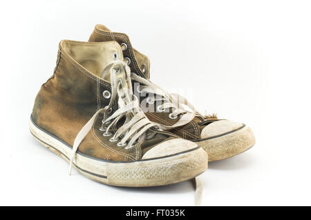 Old and dirty pair of sneakers on white Stock Photo