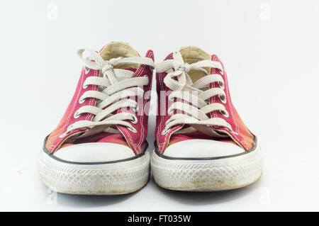 Old and dirty red sneakers on white Stock Photo