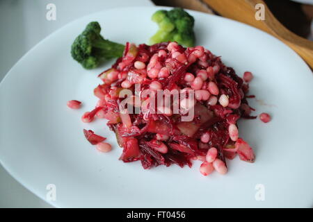 appetizing light on calorie vegetarian salad from white haricot, young beet, cucumber, broccoli under olive oil
