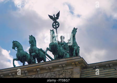 The quadriga located atop the Brandenburg Gate in Berlin, Germany,  was designed by Johann Gottfried Schadow in 1793 as the Quad Stock Photo