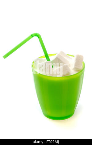 Green plastic glass with straw full of sugar and sugar cubes isolated on white background. Concept image for too much sugar in s Stock Photo