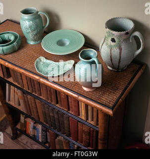 Collection of turquoise thirties pottery on a bamboo bookcase Stock Photo