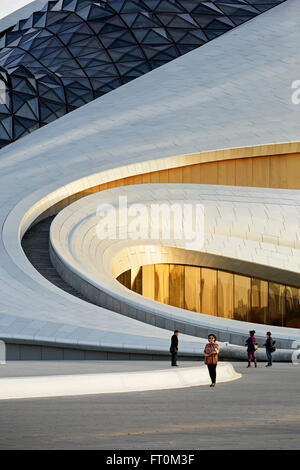 Detail of exterior facade with visitors. Harbin Opera House, Harbin, China. Architect: MAD Architects, 2015. Stock Photo