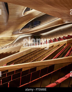 Multi-storey grand theatre interior with seating and timber sculpted wall. Harbin Opera House, Harbin, China. Architect: MAD Arc Stock Photo