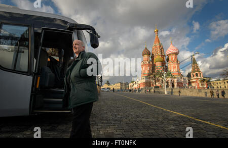 NASA astronaut Jeff Williams arrives in Moscow for traditional pre-launch ceremonies before his Expedition 47 mission. He is seen laying roses at the site where Russian space icons are buried near Red Square, with the iconic Saint Basil’s Cathedral in the background. Stock Photo