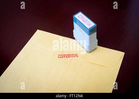 A yellow envelope stamped confidential. Stock Photo