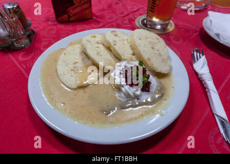 Czech food dumpling Sirloin on beef in cream sauce with cranberries served with dumplings, traditional cuisine Stock Photo