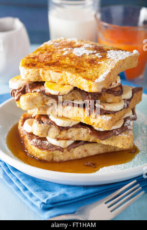 french toasts with banana chocolate sauce and caramel for breakfast Stock Photo