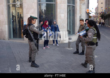 Israeli border policewoman cornering young Palestinian girls in the street for interrogation in West Jerusalem Israel Stock Photo