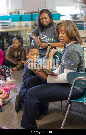 Pontiac, Michigan - Volunteers from Fiat Chrysler read to second graders at Herrington Elementary School on 'Read Aloud Day.' Stock Photo