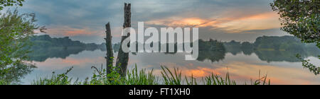 Panoramic scene of Attenborough nature reserve at sunset reflected in the water. Nottinghamshire, September Stock Photo