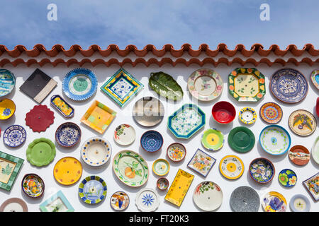 SAGRES, PORTUGAL - OCTOBER 13,2015: portuguese handcrafted, colorful decorated plates on the wall - traditional ceramic. Stock Photo