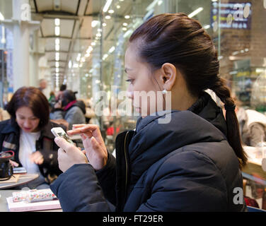 A lady sending messages on her smart phone. Stock Photo
