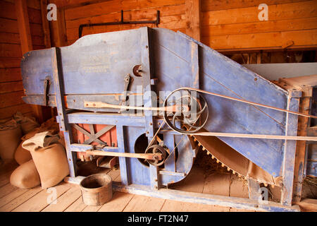 CAVENDISH, PEI - SEPTEMBER 1, 2013: The hay press, often housed in its own special barn, compressed hay into bales for easier st Stock Photo