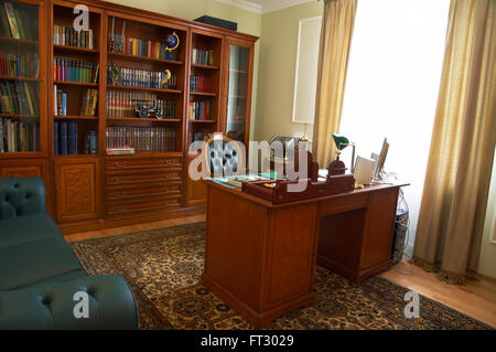 Bookcase, table and chair in a cabinet Stock Photo