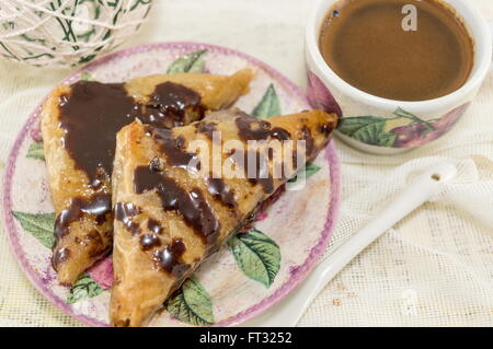 Homemade baklava on a plate and hot cup of coffee Stock Photo