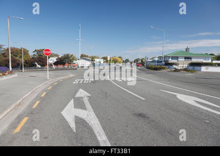 White arrows painted on road at STOP junction, cross road in Timaru,Canterbury,South Island,New Zealand Stock Photo