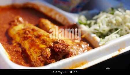 Mississippi style chili tamales in a takeout (takeaway) container Stock Photo