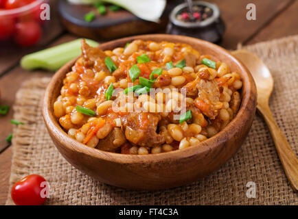 Steamed white beans with meat in tomato sauce Stock Photo