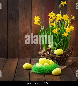 Easter eggs and flowers on a dark wooden background Stock Photo