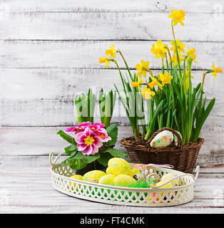 Nest with beautiful Easter eggs and flowers on grey background Stock ...