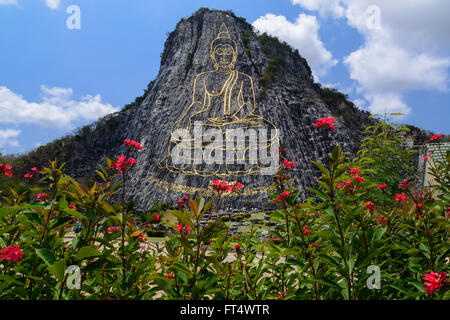 Buddha carved on on cliff mighty laser, the major attractions of Pattaya city, Thailand Stock Photo