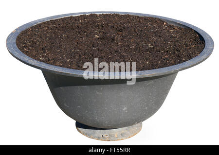 The pig-iron street flower vase is filled with compost. Isolated with patch Stock Photo