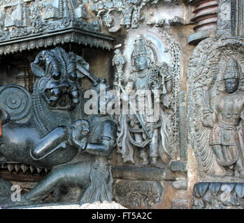 Stone carved human and animal figures on outer walls of Chennakesava Temple in Belur, Karnataka Stock Photo