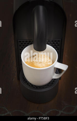 Delicious cup of espresso being poured from a domestic espresso machine Stock Photo