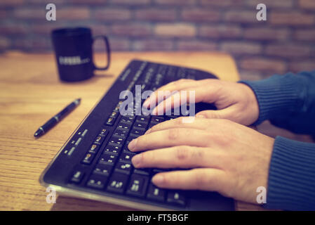 Male hands typing on computer keyboard Stock Photo